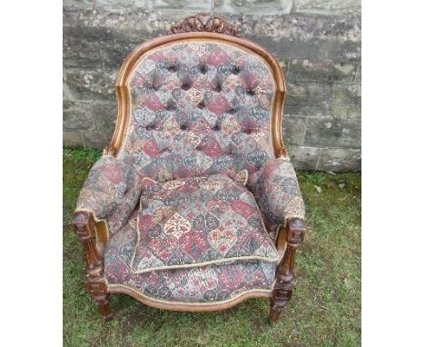 A 19th century show wood grandfather's chair, with deep button upholstery and fluted front legs