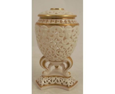 A 19th century unmarked Worcester reticulated covered vase, the body of egg form raised on three supports to a triform base, 