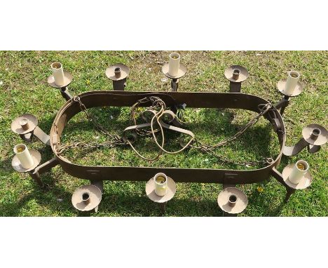 A metal hanging light fitting, having six candle holders and six light fittings, 42ins x 23ins