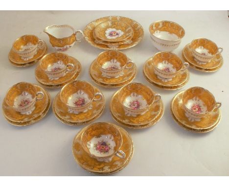 A thirty-five piece Royal Worcester part tea service, each piece painted to the centre with a floral spray by Earnest Barker,