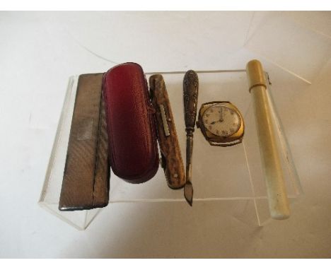 A hallmarked silver comb case, with engine turned decoration, together with an ivory needle case and needles, a cigar holder 