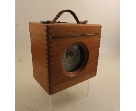 A cased pigeon racing clock, of circular form, bearing label Automatic Time Clock Company Limited of Lancashire