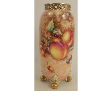 A Royal Worcester cylindrical vase, decorated with fruit to a mossy background by Freeman, with pierced gilt neck, raised on 