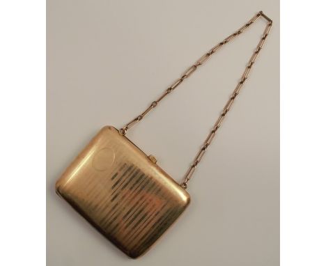 A yellow metal lady's coin purse, with engine turned decoration, marked 12KT, with chain handle, total weight 98g