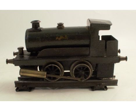 A painted metal locomotive engine, with a section of track
