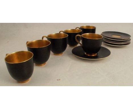 A set of six Royal Worcester coffee cups and saucers, decorated in matt black and gilt, dated 1937 -&nbsp;One handle broken a