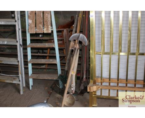 A bundle of long handled gardening tools