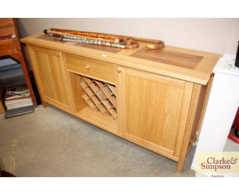 A light oak sideboard fitted single drawer with integral wine rack 
