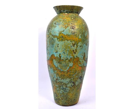 A 19th century ceramic pottery table vase. Of circular form with flared rim into a tapering body. With tones of green and blu