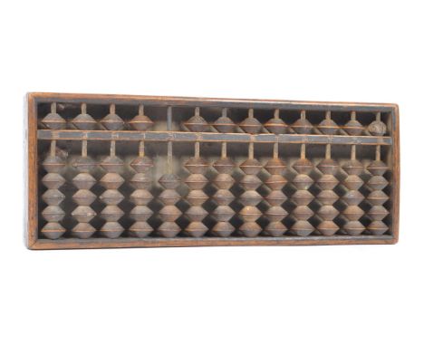 An early 20th Century wooden Chinese abacus with stamp to back. Measuring approximately 29cm x 11cm.&nbsp;