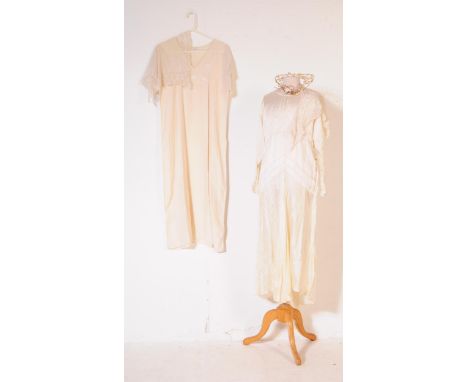 An early 20th Century 1920s vintage ivory coloured silk wedding dress, comprising of both under and outer garments, one with 