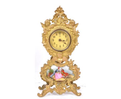 A 20th Century gilt metal brass continental Rococo style mantel / table clock with ceramic courting scene below the face, fra