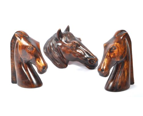 Two solid wood horse head carved bookend sculptured figures accompanied by a wooden horse head wall hanging of side profile w