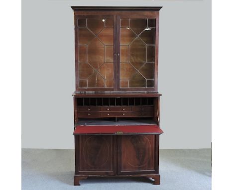 A large 19th century mahogany estate cabinet, with a glazed upper section, fitted with a secretaire, on bracket feet, 127cm