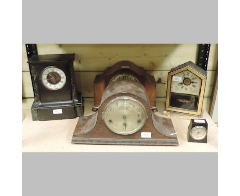 An early 20th century black slate mantel clock, 18cm tall, together with an ebonised and painted glass mantel clock, and thre