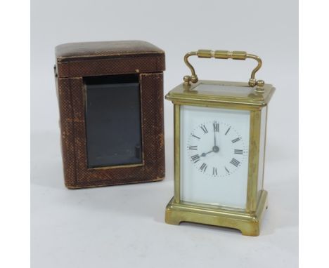 An early 20th century brass cased carriage clock, 14cm tall overall, in a fitted case