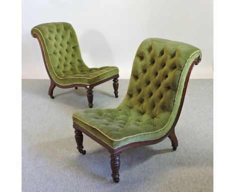 A pair of Victorian mahogany and green upholstered button back armchairs