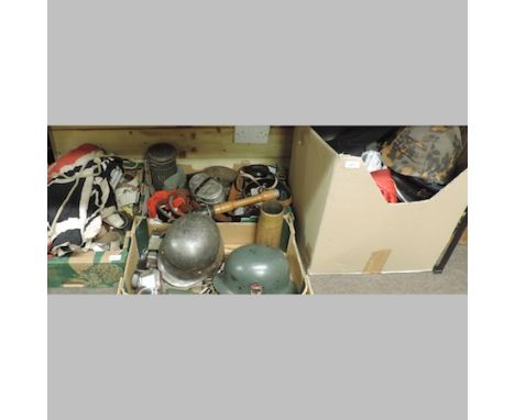 A large collection of reproduction military items, to include German army helmets, hats, belts and epaulettes, together with 