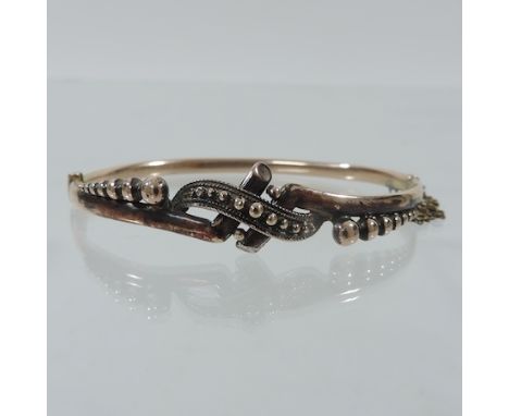 A Victorian hinged bangle, marked 9 carat, in a fitted box
