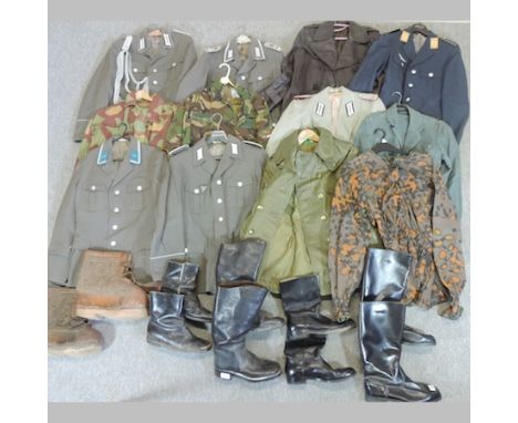 A collection of military style clothing, to include leather jackets and a collection of army boots
