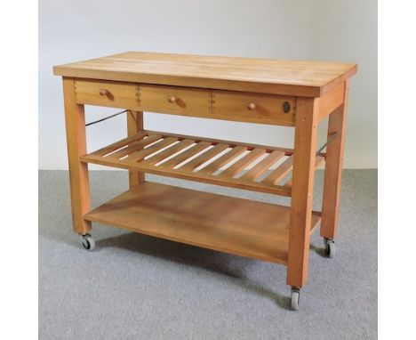 A beech and pine butchers block kitchen island, with shelf below, on castors, 120cm