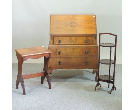 A 20th century walnut bureau, 77cm, together with a folding cakestand, two fire screens, an oak stool, a carved pine trunk, a