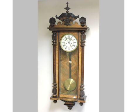 A late 19th century walnut cased Vienna style regulator, with a white enamel dial, 123cm tall