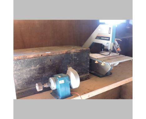 A Black and Decker band saw, together with a bench grinder and a pillar drill and vintage tool box