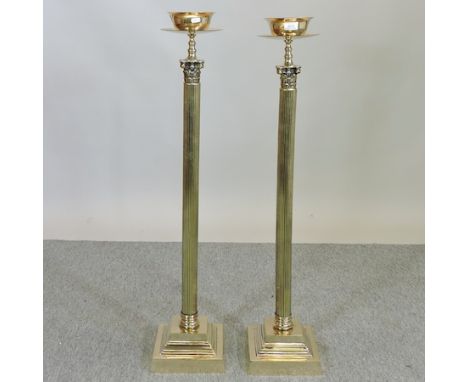 A pair of brass Corinthian column altar sticks, 106cm tall