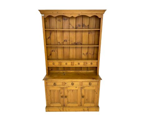 Pine kitchen dresser fitted with three tier plate rack and four spice drawers, above three drawers and cupboards Dimensions: 