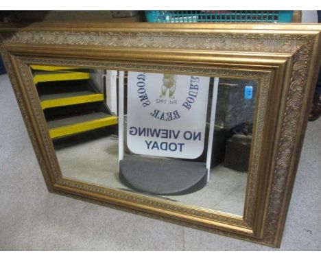 A large gilt decorated modern wall mirror, 48" h x 37" w 