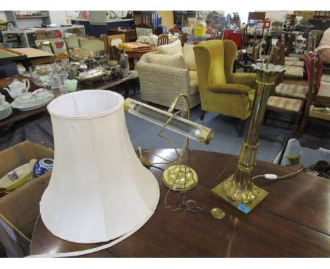 A brass table lamp with a fabric shade and a brass effect desk lamp 