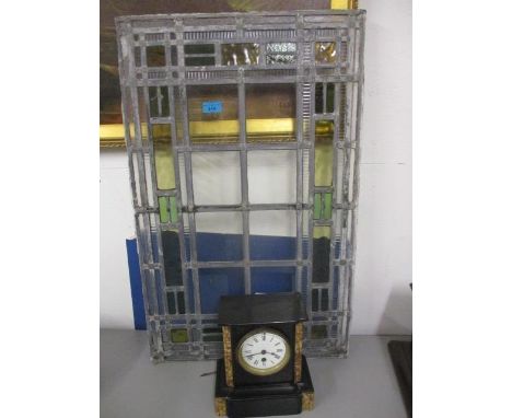 An early 20th century stained glass window and a slate and marble cased mantle clock 
