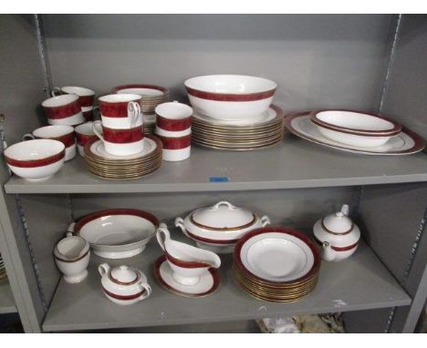 A Spode Bordeaux pattern dinner service decorated with a mottled red band and gilt ornament 