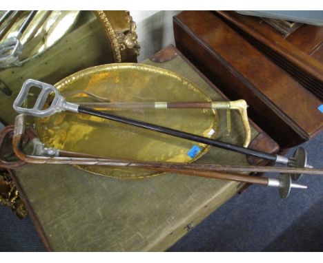 A mixed lot to include two shooting sticks, a whip, a silver capped stick and a brass tray