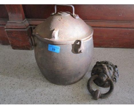 A cast iron cooking pot and a lion head door knocker 