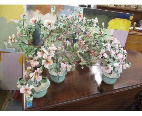 A selection of hardstone and jade decorative plants in celeadon glazed pots 