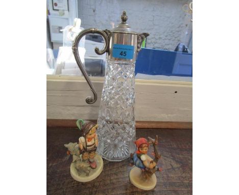 A silver plated and cut glass claret jug, together with two Hummel figures 