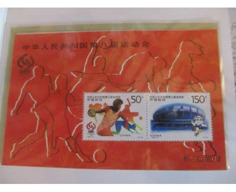 Two albums containing Chinese postage stamps, postcards and first day covers 
