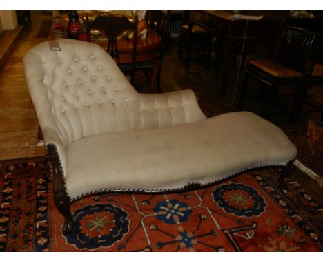 A 19th century French walnut chaise long, button back upholstered in an ivory fabric, having serpentine shaped stuff over sea