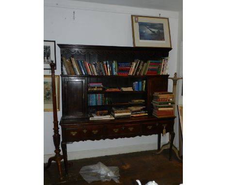 A George II oak high back dresser, having an ogee moulded cornice above a pierced apron, over three shelves, flanked by field