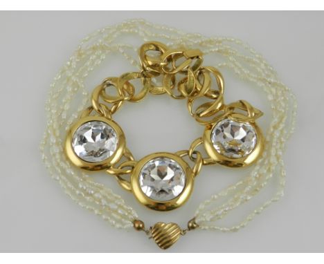 A five strand pearl necklace with a gilt metal clasp, together with a large gold tone costume necklace. (2)