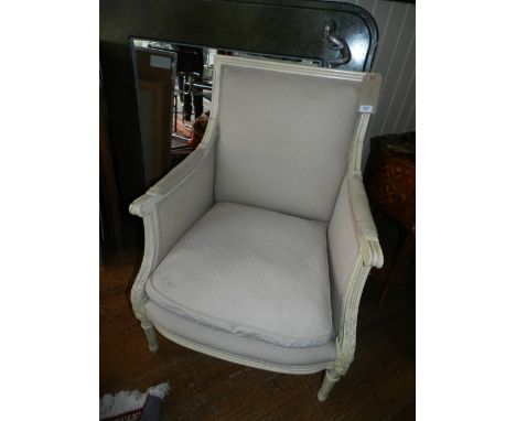 An early 20th century cream painted bergere elbow chair, in the Louis XVI style, fitted tapestry woven swab cushions raised o