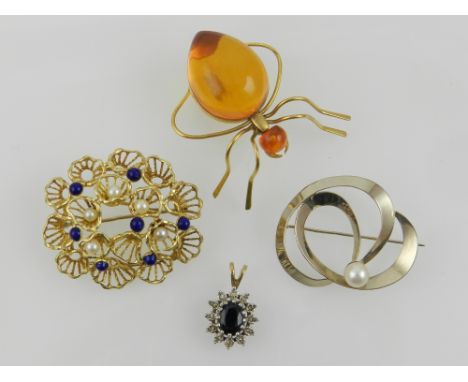 A yellow metal and amber style spider brooch; a yellow metal brooch set with small pearls and blue cabochon stones; a white m
