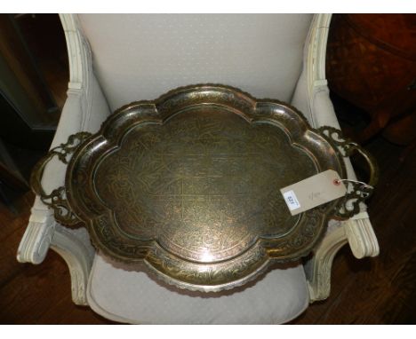 An Eastern brass and enamel twin-handled tea tray, hand rendered Kufic script.  W.72cm