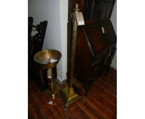 An early 20th century Corinthian column standard lamp raised on claw feet. H: 128cm