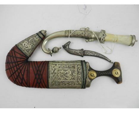 A Persian Qajar dagger, the scabbard with filigree decoration. L.34cm, together with a niello work and Damascus steel dagger 