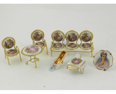 Three limoges porcelain miniature, together with a miniature porcelain mounted gilt metal three seated sofa, matching pair of