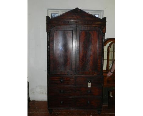 A William IV mahogany linen press, having an architectural cornice above a pair of fielded panelled cupboard doors, flanked b