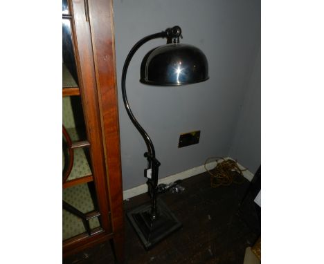An Art Deco style nickel plated adjustable study lamp, having dome shade, raised on stepped square base. 